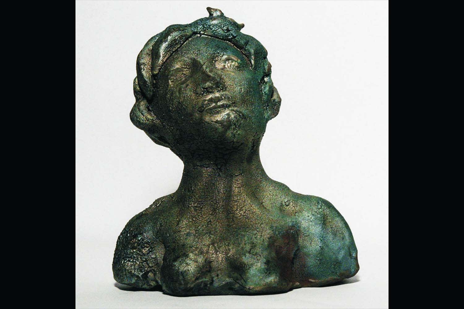 Linda Szoldatits, Ceramic bust of woman wearing a headpiece.